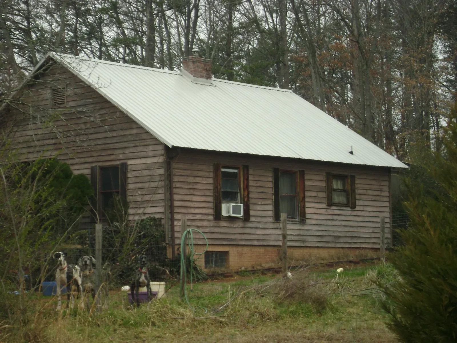 White metal roof on an old wood sided farmhouse, from a Metal Roof Installation job in Montclair